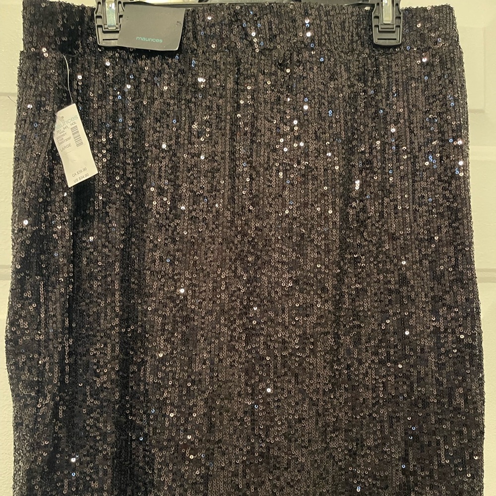 Black sequin skirt thigh length. Only worn once to model in store.